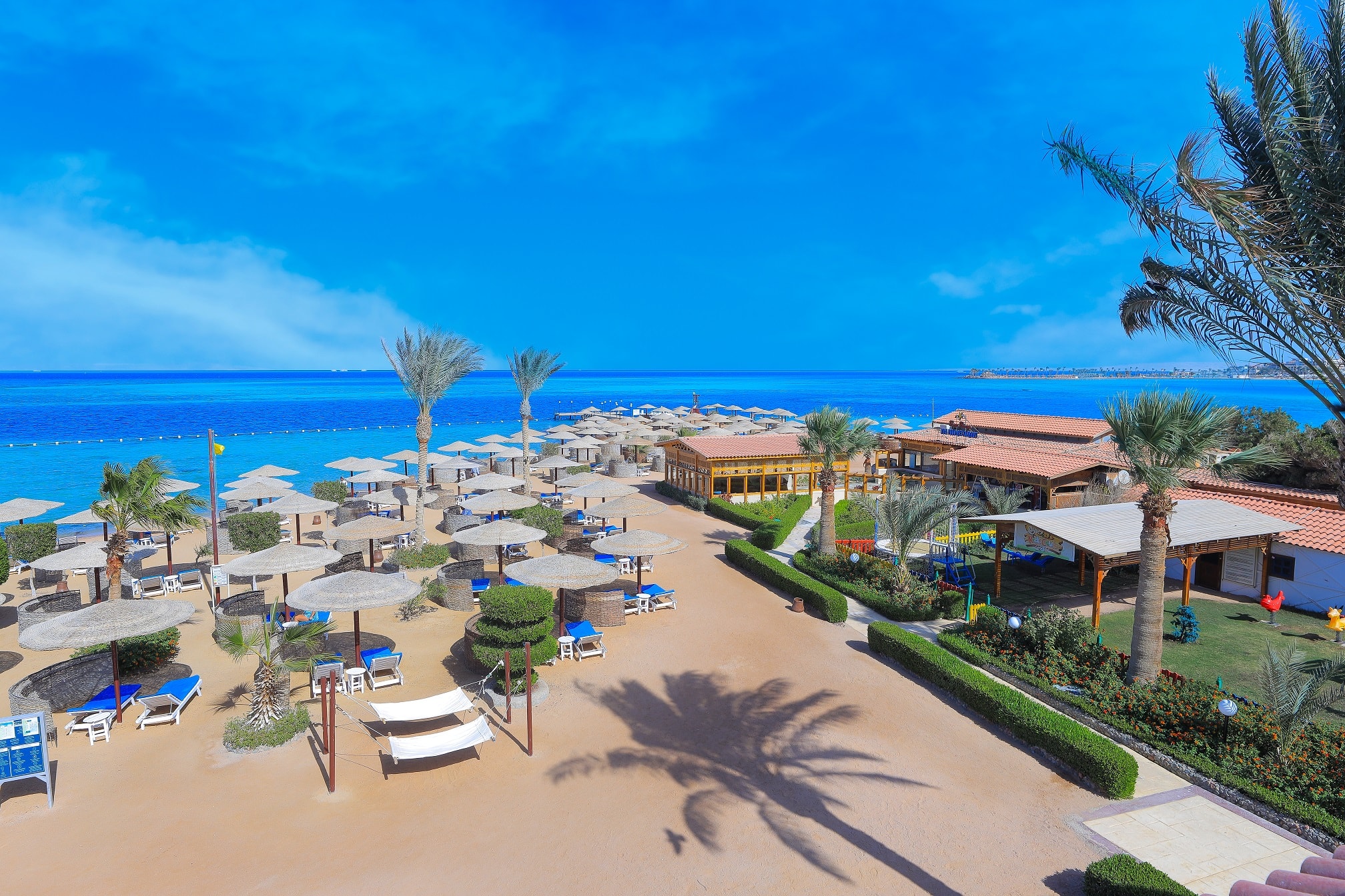 Private sandy beach with sun loungers